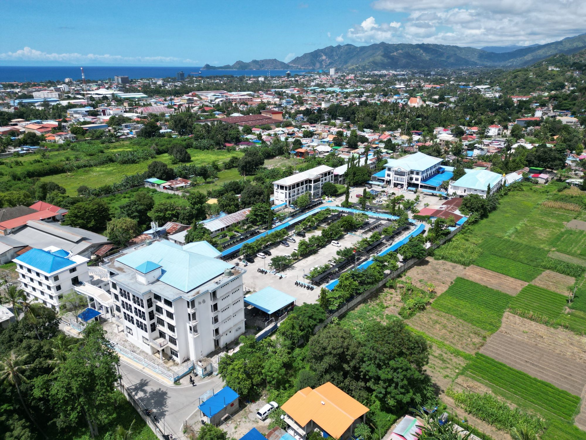 Aerial view of the UNPAZ campus with Dili and the sea beyond